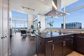 Austin apartment for rent - A modern kitchen with dark wood floors and a large island.