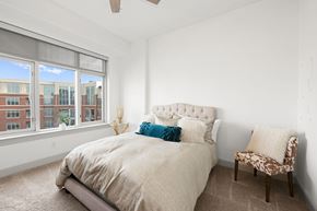 Charlotte apartment for rent - A bedroom with a large bed and a chair.
