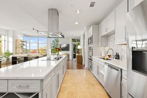 Charlotte apartment for rent - A modern kitchen with a long counter and stainless steel appliances.
