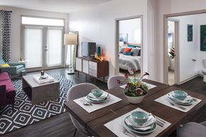 Denver apartment for rent - A modern dining room with a wooden table set for two.