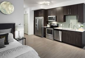 Denver apartment for rent - A modern kitchen with dark wood cabinets and stainless steel appliances.