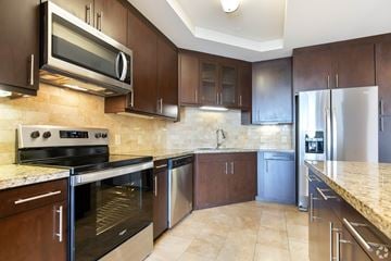 San Francisco apartment for rent - A kitchen with brown cabinets and stainless steel appliances.