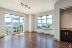 San Francisco apartment for rent - A spacious room with a view of the city through the windows.