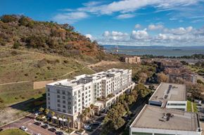 San Francisco apartment for rent - A large white building with a parking lot in front of it.