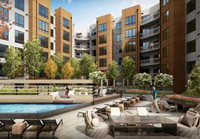 Alexandria apartment for rent - A man is walking in a courtyard with a pool and chairs.