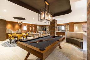 Alexandria apartment for rent - A pool table is in the middle of a room with a couch and chairs.