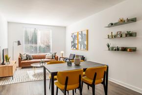 Alexandria apartment for rent - A modern dining room with a black table and yellow chairs.