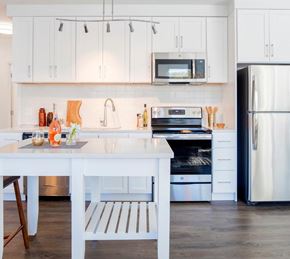 Alexandria apartment for rent - A white kitchen with a table and a fridge.