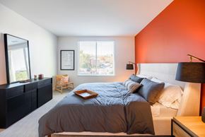 Alexandria apartment for rent - A bedroom with a large bed and a wooden nightstand.