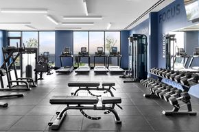 New Rochelle apartment for rent - A gym with a variety of equipment including treadmills, weights, and exercise machines.