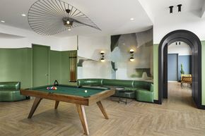 New Rochelle apartment for rent - A pool table is in the middle of a room with green walls.