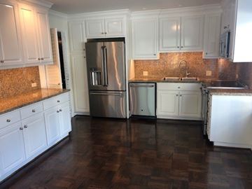 San Francisco apartment for rent - A kitchen with white cabinets and a stainless steel refrigerator.