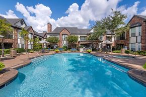 Houston apartment for rent - Large outdoor pool surrounded by trees at Joule on Memorial apartments in Harris County, TX.