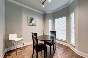 Houston apartment for rent - A dining room with a table, chairs and a painting on the wall.