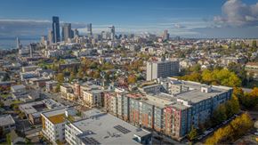 Seattle apartment for rent - A cityscape with buildings of various heights and colors, with a clear sky above.