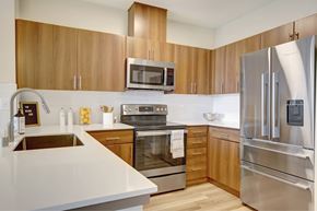 Seattle apartment for rent - A modern kitchen with wooden cabinets and stainless steel appliances.