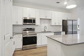 Charlotte apartment for rent - A kitchen with white cabinets and stainless steel appliances.