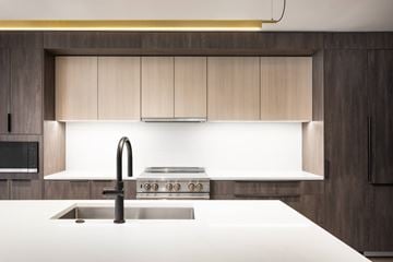 Denver apartment for rent - A modern kitchen with a stainless steel sink and a stove top.