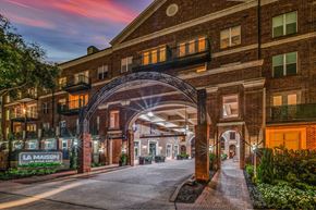 Houston apartment for rent - The image shows a building with a sign that reads "LA MAISON".