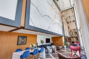 Houston apartment for rent - A modern dining area with a white table and blue chairs.
