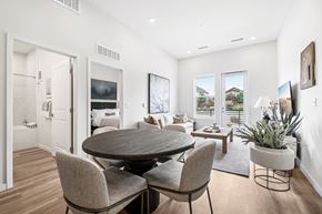 Aurora townhouse for rent - A modern dining room with a round table and chairs.