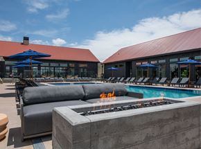 Aurora townhouse for rent - A pool area with a fire pit in the center.