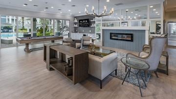 Orlando apartment for rent - A modern living room with a pool table and a fireplace.