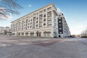 Richardson apartment for rent - A large white building with many windows and balconies.