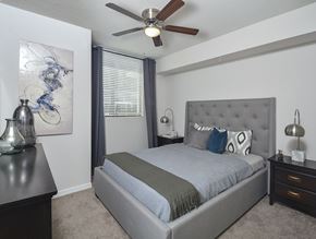 Miami apartment for rent - A bedroom with a bed, nightstands, and a ceiling fan.