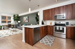 San Jose apartment for rent - A modern kitchen with wooden cabinets and stainless steel appliances.