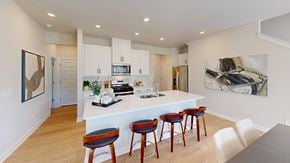 Fountain Inn apartment for rent - A kitchen with a white counter and bar stools.
