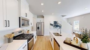 Fountain Inn apartment for rent - A modern kitchen with white cabinets and stainless steel appliances.