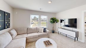 Fountain Inn apartment for rent - A living room with a grey sofa, a white coffee table, and a television.