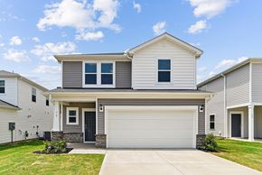 Fountain Inn apartment for rent - A two-story house with a garage door and a driveway.