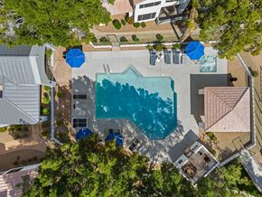 Glendale apartment for rent - An aerial view of a swimming pool surrounded by trees and buildings.