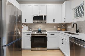 Glendale apartment for rent - A modern kitchen with white cabinets and stainless steel appliances.
