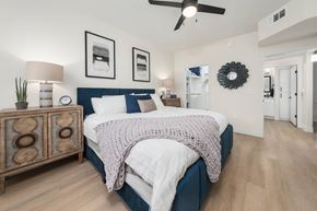 Glendale apartment for rent - A bedroom with a bed, nightstand, and a ceiling fan.