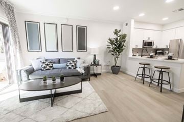 Peoria apartment for rent - A modern living room with a grey sofa and a coffee table.