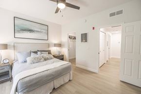 Peoria apartment for rent - A bedroom with a large bed and a ceiling fan.
