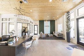 Peoria apartment for rent - A modern clubhouse with a reception desk and seating area.