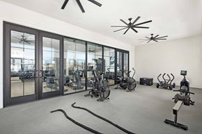 Folsom apartment for rent - A gym with exercise equipment and a large window.