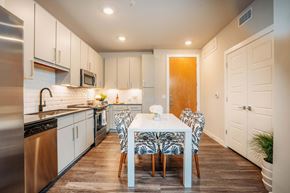 Dallas apartment for rent - A modern kitchen with a dining table set for two.