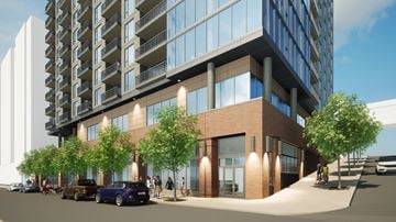 Duluth apartment for rent - A modern building with a parking lot in front.