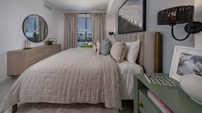 Miami apartment for rent - A bedroom with a large bed and a green dresser.