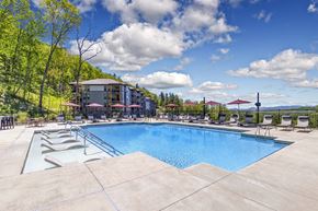 Asheville apartment for rent - A large outdoor swimming pool with a mountain in the background.