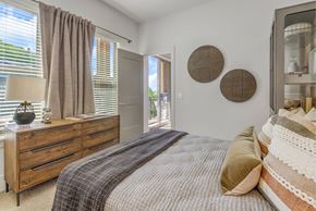Asheville apartment for rent - A bedroom with a bed, dresser, and window with curtains.