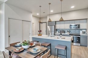 Eugene apartment for rent - A modern kitchen with a dining table set for two.