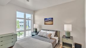 Eugene apartment for rent - A bedroom with a large bed and a painting on the wall.