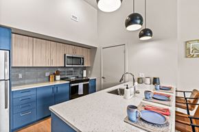 Eugene apartment for rent - A kitchen with a blue cabinet and a white counter.
