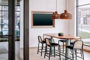Kansas City apartment for rent - A modern dining room with a wooden table and chairs.